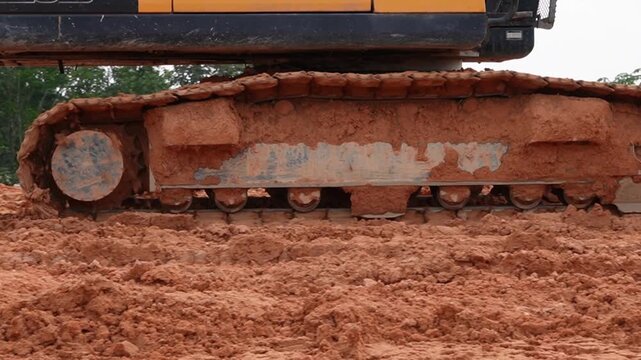 Dynamic movement of excavator crawler track across rugged terrain