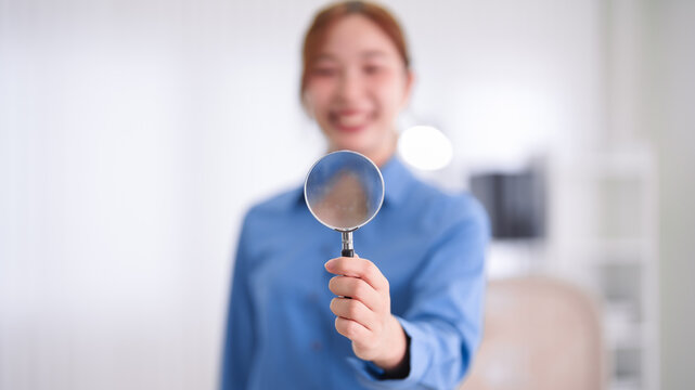 Asian business women holding magnifying glass showing search analysis research concept professional businesswoman investigating marketing data office workplace