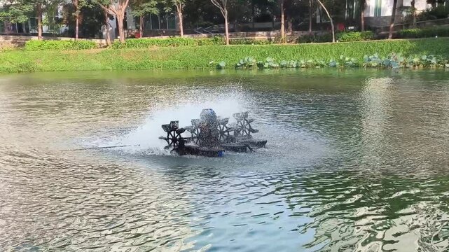 Paddle wheel aerators are commonly used in fish farming to increase dissolved oxygen levels. The aerator motor produces a loud noise and rumbling water splashes.