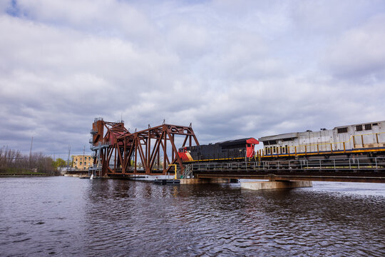 A train crossing a drawbridge over a river.