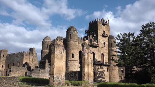 Explore the ancient ruins of a castle in Gondar, Ethiopia during a bright afternoon