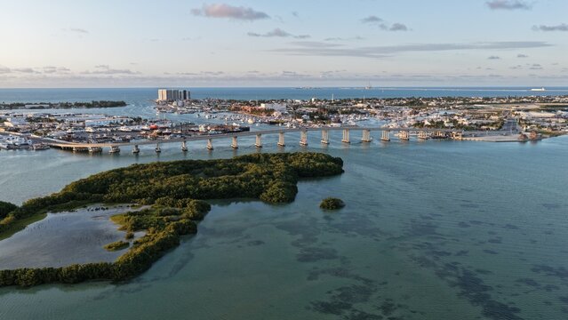 Aerial view of Yucalpeten bridge spanning the turquoise water near lush mangroves and the harbor Progreso, Yucatan, Mexico.