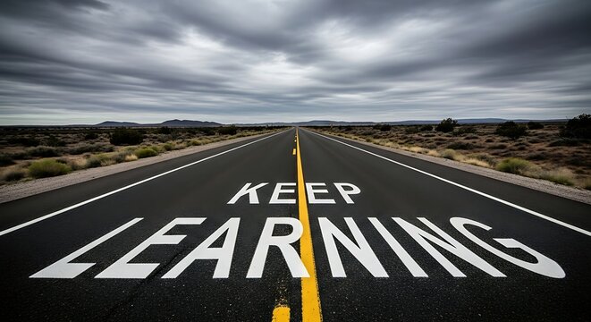 Keep Learning Text Painted on Straight Desert Highway Road Under Dark Cloudy Sky
