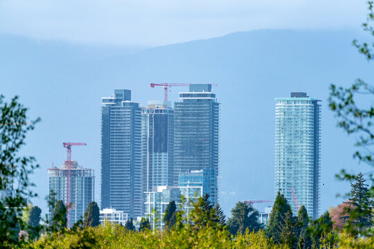 Modern High Rise Towers and Construction Cranes in Metro Vancouver Skyline