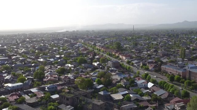 This stunning aerial drone video captures the historic city of Gyumri in Armenia, showcasing its old rooftops, busy pedestrian streets, and beautiful autumn colors on a clear day.

