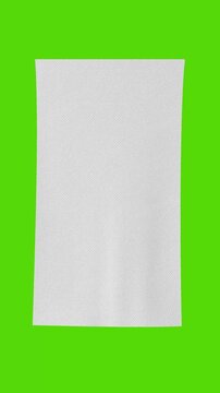 4k Resolution Vertical Video for Social Media: Textile Material And Mockup Concept. Unrolled White Cloth Fabric Sheet With Subtle Texture On On Green screen Chroma Key Background With Alpha Matte