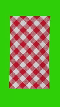 4k Resolution Vertical Video for Social Media: Picnic And Rustic Dining Concept. Red And White Checkered Cloth Fabric Mockup Unrolled Animated On Green Screen Chroma Key Background With Alpha Matte