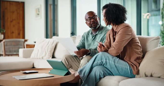 Couple, documents and tablet with budget in lounge for review, point and insight for investment. Mature, man and woman with paperwork, admin and financial report for asset management on couch