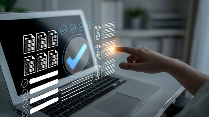 A hand interacts with a digital interface on a laptop, illustrating document verification and...