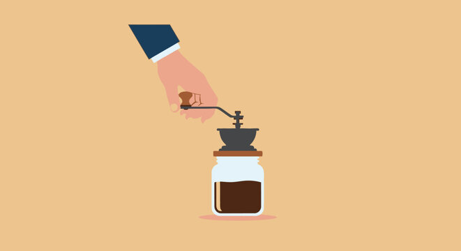 Hand grinding fresh coffee beans with manual grinder tool.