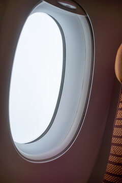 View of an window from the interior of airplan, with an empty view