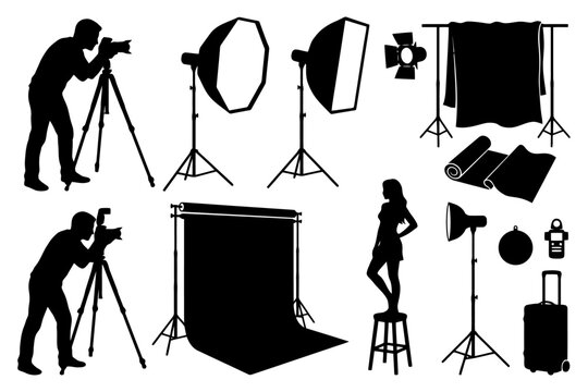 Photography studio setup with equipment and silhouette of photographer and model.