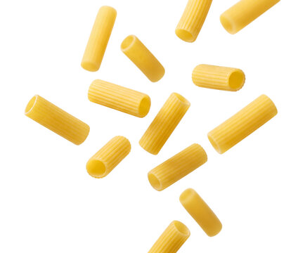 Rigatoni pasta pieces suspended in air on transparent background