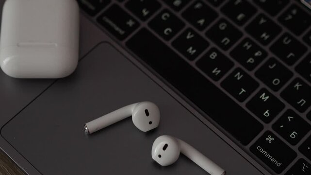 White plastic wireless headphones on the table