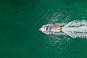 Fototapeta premium Yacht luxury view at sea. Vacation on summer. Summertime motorboat tour. Luxury motor boat yacht. Yacht go to marina. Boating and yachting. Luxury lifestyle. Marina yacht club