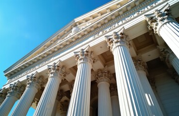 Fototapeta premium Majestic courthouse building with large stone columns against clear blue sky. Grand architecture justice, law. Sunlight highlights facade details, creating strong shadows. Structure represents