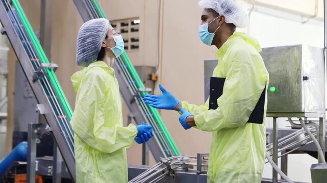 Supervisors wearing personal protective equipment (PPE) meticulously inspect mackerel or sardine production lines and shake hands in greeting at industrial seafood processing plants.
