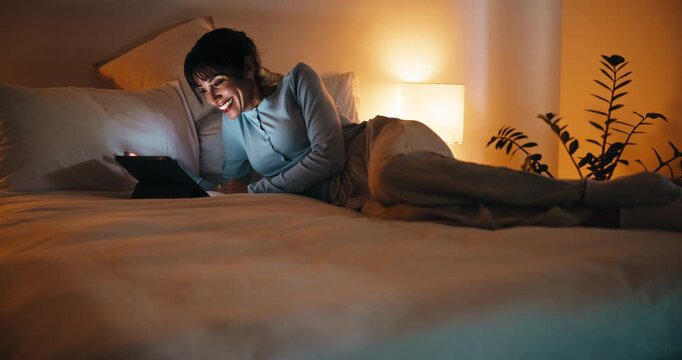 Relax, tablet and night with happy woman on bed for online streaming, entertainment or laughing. Female person, smile and watching with technology in late evening for subscription or app in home
