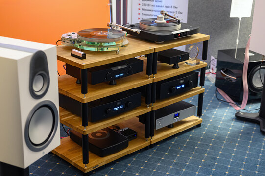 Moscow, Russia - October 20, 2024: Hi-End audio system - players and amplifiers from the Norwegian company Hegel, mounted on a wooden stand