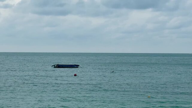 A boat is floating in the middle of blue ocean , in Koh samed thailand , video.