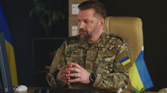 Middle-aged Ukrainian army general controlling special operation on computer