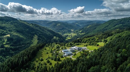 Fototapeta premium Aerial view valley green hydrogen plant integrated among forested hills, small industrial campus adjacent to river and winding road, sunlight filtering through scattered clouds, surrounding patches