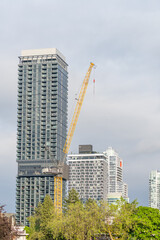 Fototapeta premium Urban High Rise Tower and Construction Crane in Vancouver Skyline