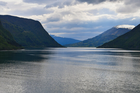 Norwegian Fjord Route to Stavanger With Snow Capped Mountains and Moody Sky