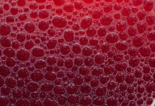 Red bubbles forming liquid foam texture