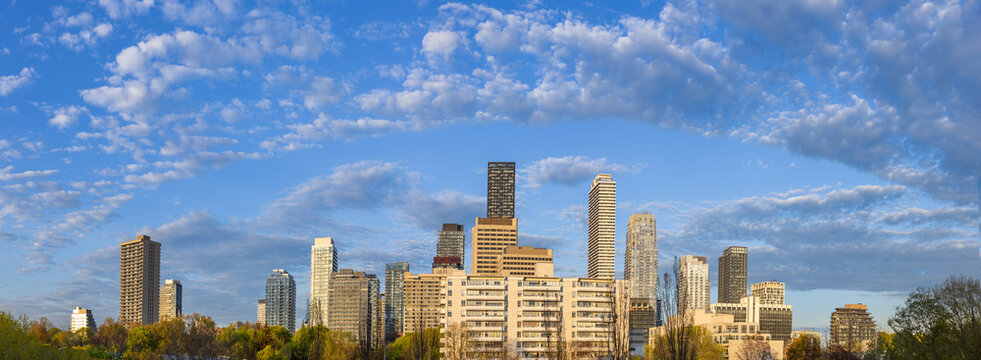 A wide panoramic skyline view of high rise apartment buildings and residential condominium development in the Yonge and Eglinton neighborhood of Toronto Canada
