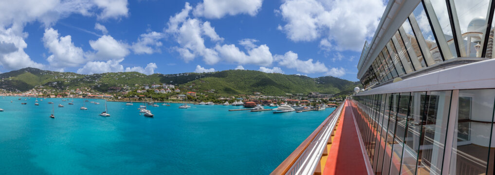 A wide panoramic shot of the turquoise bay and lush green hills of Charlotte Amalie in Saint Thomas US Virgin Islands taken from the promenade deck of a cruise ship