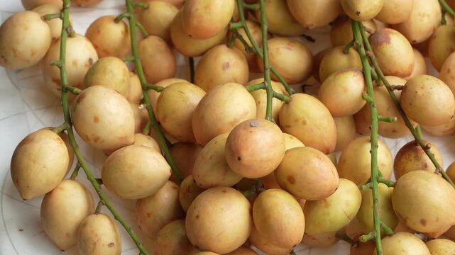 Full frame macro background of fresh open-air Ha Chau Baccaurea fruits pattern.