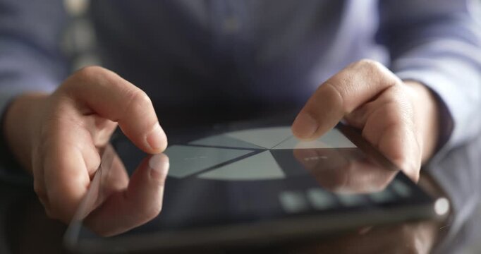 Reviewing financial data on tablet in office