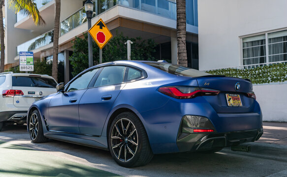 Miami, Florida, USA - December 06, 2025: BMW i4 electric liftback sedan coupe style car. Electric car BMW i4. Car BMW i4 parked outdoor. Blue electric car, corner view