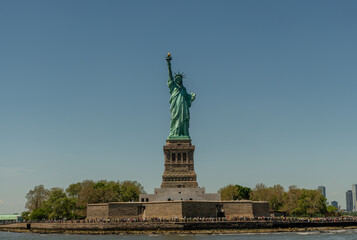 Fototapeta premium Statue of liberty on a clear summer day viewed from a boat, New York City