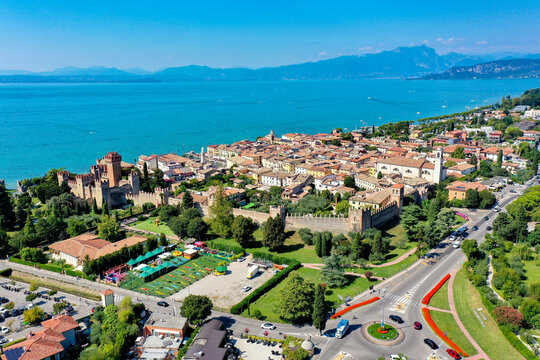 Aerial view of the historic town of Lazise and Scaligero Castle on the shores of Lake Garda with medieval walls and colorful buildings in Provincia di Verona, Veneto, Italy.