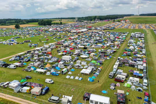 Aerial view of the Open Beatz Festival camping area with rows of tents and camper vans parked on a large green field Herzogenaurach, Bayern, Germany.
