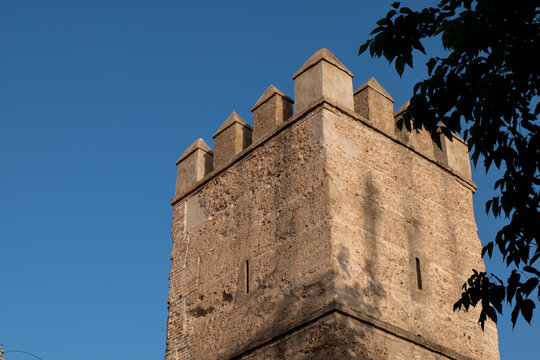 Close up of medieval Torre Blanca stone tower under blue sky in Seville Spain