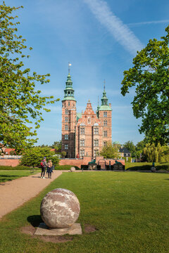 Rosenborg Castle in Copenhagen, Denmark. Historic renaissance palace in the King's Garden on a bright sunny spring day with green trees and blue sky.