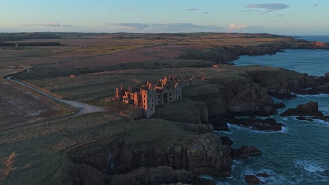 Slains castle ruins aerial view at sunset on the aberdeenshire coast