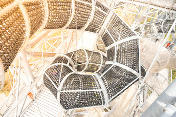Fototapeta premium Visitors explore the climbing frame at Sky Walk Tower in Swieradow Zdroj. The structure offers fun and adventure as people navigate the unique pathways high above the ground.