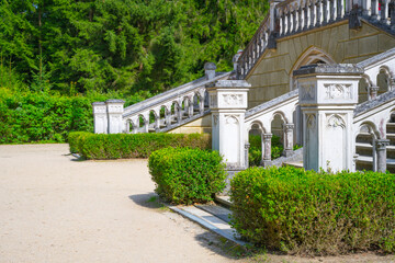 Fototapeta premium The staircase of the Schwarzenberg Tomb in Domanin shows detailed architecture surrounded by greenery. Visitors may admire the design and craftsmanship as they explore the area.