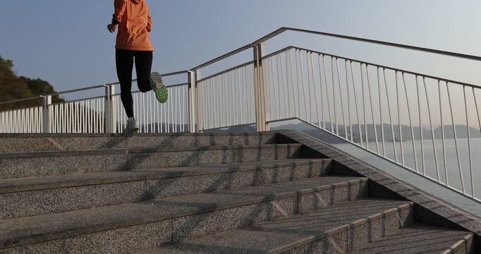 Fitness sports woman runner running on seaside trail, slow motion