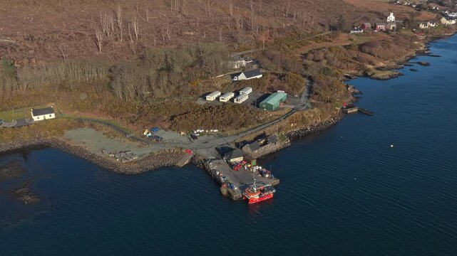 Aerial view of a fishing boat docked at uig pier on the isle of skye