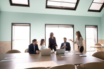 Fototapeta premium Group of diverse staff members having corporate meeting discussion in conference room. Business communication, team collaboration during teamwork, strategy planning, training, decision making concept