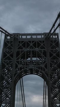 point of view of car driving over george washington bridge between fort lee new jersey and manhattan york heights (sunset night time cloudy suspension bridge)