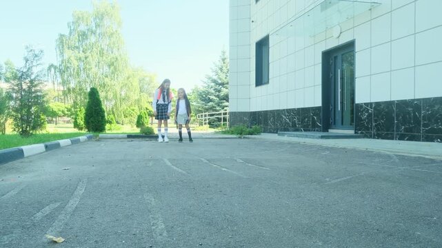 First day of school with student standing outside school building in real back to school season atmosphere