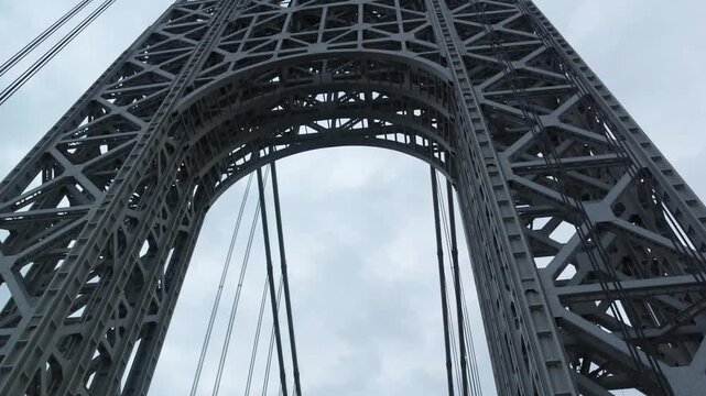 point of view of car driving over george washington bridge between fort lee new jersey and manhattan york heights (sunset night time cloudy suspension bridge)
