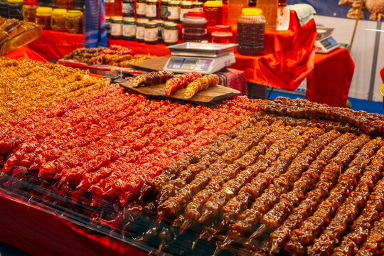 Cevizli sucuk. Traditional Turkish cuisine dessert. Walnut sausage dessert at local market stall in istanbul. Variety of sweets on the arab street market stall. Eastern sweets in a wide range, baklava