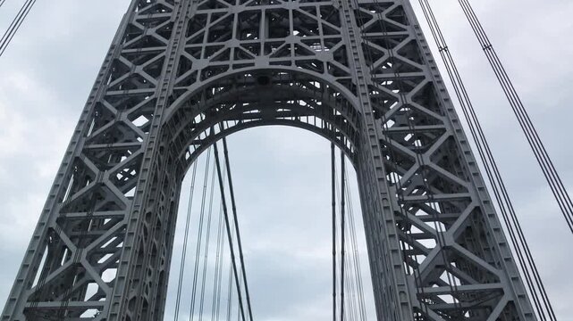 point of view of car driving over george washington bridge between fort lee new jersey and manhattan york heights (sunset night time cloudy suspension bridge)
